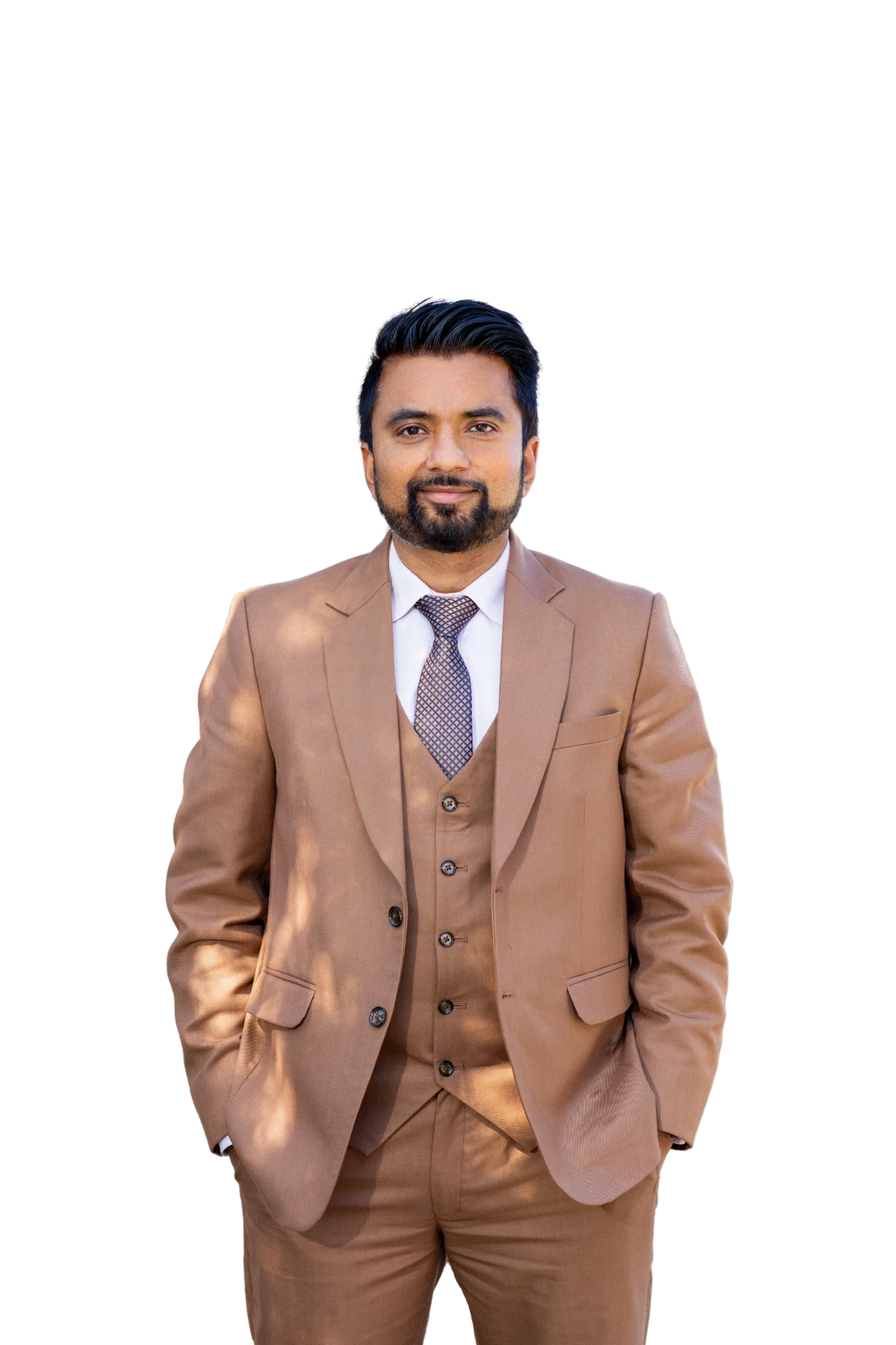 Sam Singh, Christchurch real estate agent, in a tan three-piece suit